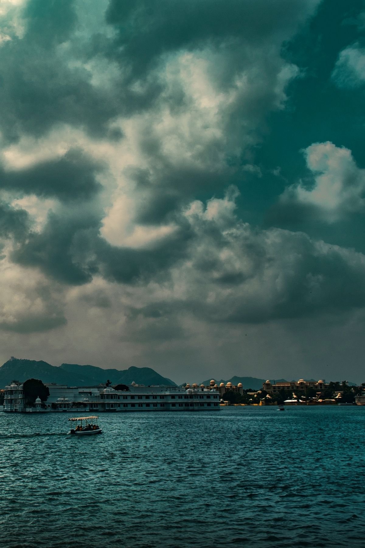 Twilight Reflections by the Lake A glowing lantern beside a tranquil lake at twilight, reflecting the timeless charm of the cityscape.