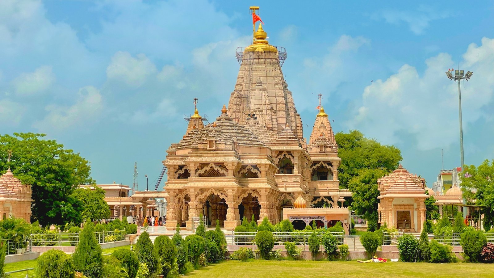Sanwaliya Ji Temple near Chittorgarh, Rajasthan, with ornate architecture and devotees offering prayers to the black stone idol of Lord Krishna.